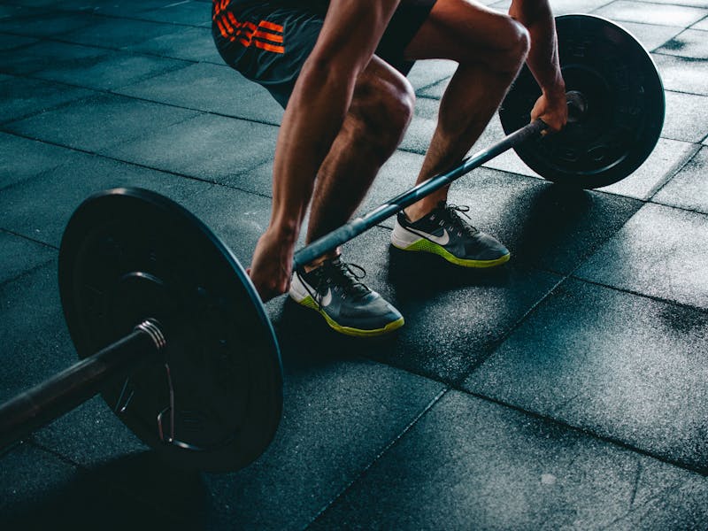 Person lifting weights in a professional gym setting